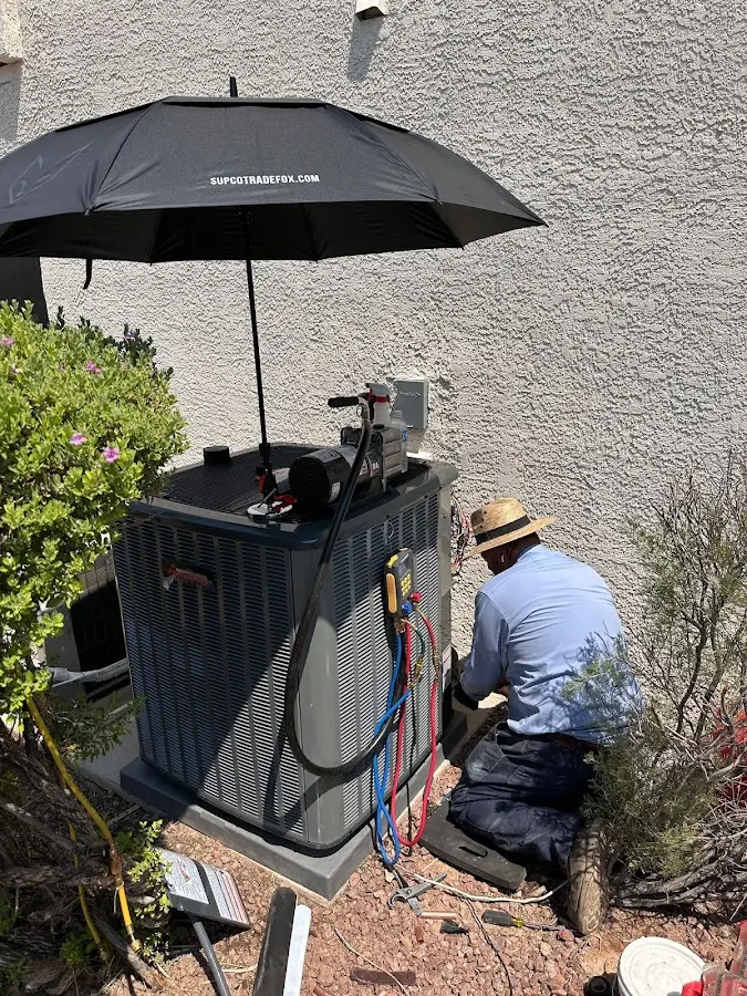 HVAC technician performing outdoor AC maintenance in Mascotte